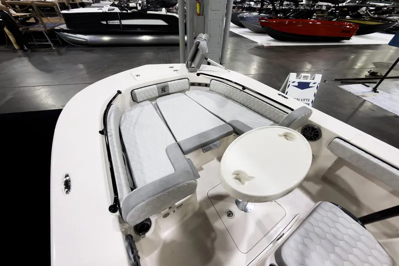 Slide: The Image of 2026 Carolina Skiff 22 Ultra Elite boat interior with seating and table at a boat show. - 86