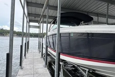 Slide: The Image of 2007 Cobalt 302 boat docked under a covered marina on a lake. - 10