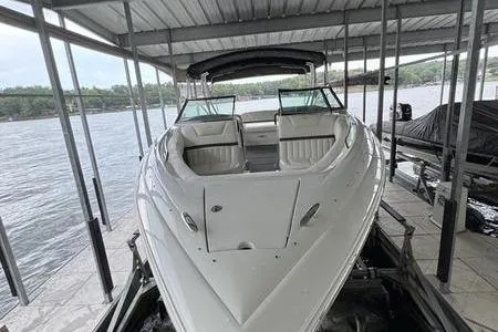Slide: The Image of 2007 Cobalt 302 boat docked under a covered marina on a lake. - 11