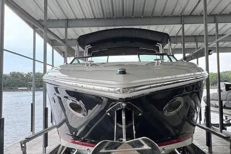 Slide: The Image of 2007 Cobalt 302 boat docked under a covered marina, front view. - 12
