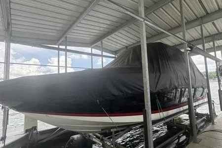 Slide: The Image of 2007 Cobalt 302 boat covered in a dock, under a metal roof. - 13