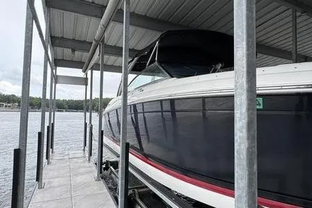 Slide: The Image of 2007 Cobalt 302 boat docked under a covered marina on a lake. - 15