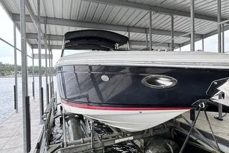 Slide: The Image of 2007 Cobalt 302 boat docked in a covered marina, side view. - 16