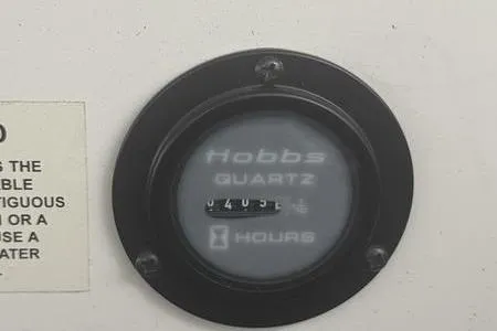 Slide: The Image of Hobbs hour meter on 2007 Cobalt 302 boat dashboard, displaying usage hours. - 17