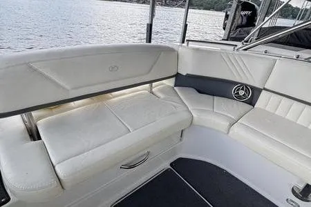 Slide: The Image of 2007 Cobalt 302 boat interior with white leather seating and lake view. - 20