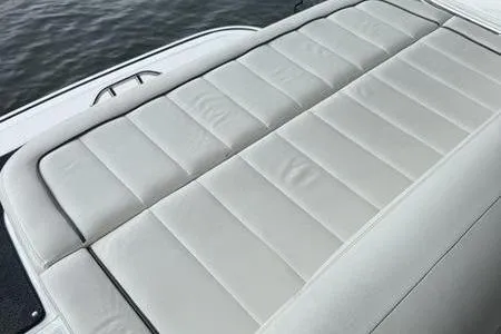 Slide: The Image of 2007 Cobalt 302 boat with sleek, cushioned seating on a calm water backdrop. - 24