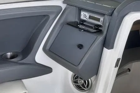 Slide: The Image of Interior of a 2007 Cobalt 302 boat featuring a stereo system and storage compartment. - 27