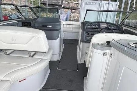 Slide: The Image of Interior of a 2007 Cobalt 302 boat with white seating and modern dashboard. - 28