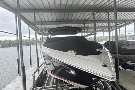 Slide: The Image of 2007 Cobalt 302 boat docked under a covered marina. - 3