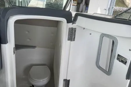 Slide: The Image of 2007 Cobalt 302 boat interior with compact bathroom and toilet. - 31