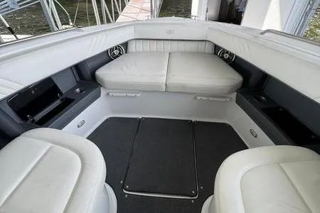 Slide: The Image of 2007 Cobalt 302 boat interior with white leather seating and storage compartments. - 32