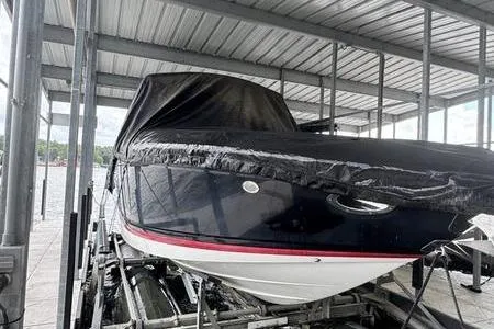 Slide: The Image of 2007 Cobalt 302 boat covered in a dock, under a metal roof. - 39
