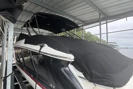 Slide: The Image of 2007 Cobalt 302 boat under cover in a docked marina setting. - 4