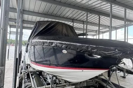 Slide: The Image of 2007 Cobalt 302 boat covered in a dock, ready for storage. - 42