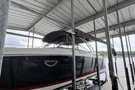 Slide: The Image of 2007 Cobalt 302 boat docked under a metal canopy on a lake. - 5