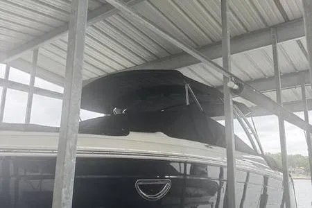 Slide: The Image of 2007 Cobalt 302 boat docked under a metal canopy. - 7