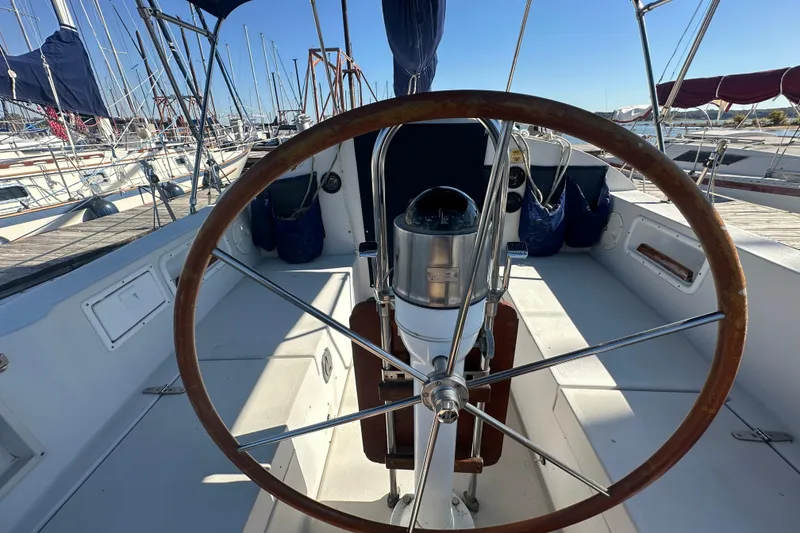Slide: The Image of Cockpit view of 1989 Nonsuch 36 sailboat with wooden steering wheel. - 10