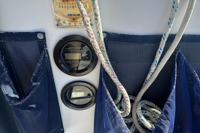 Slide: The Image of Control panel of a 1989 Nonsuch 36 sailboat with ropes and gauges. - 13