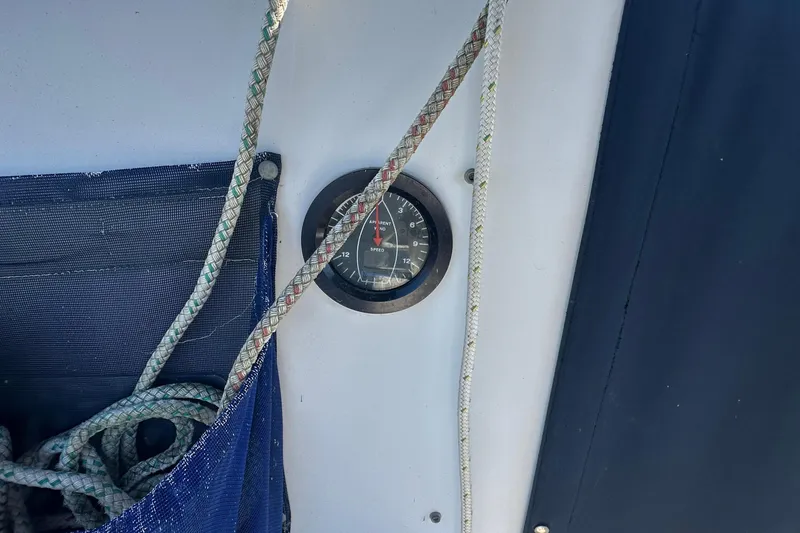 Slide: The Image of 1989 Nonsuch 36 sailboat cockpit with ropes and gauge, blue cover visible. - 14