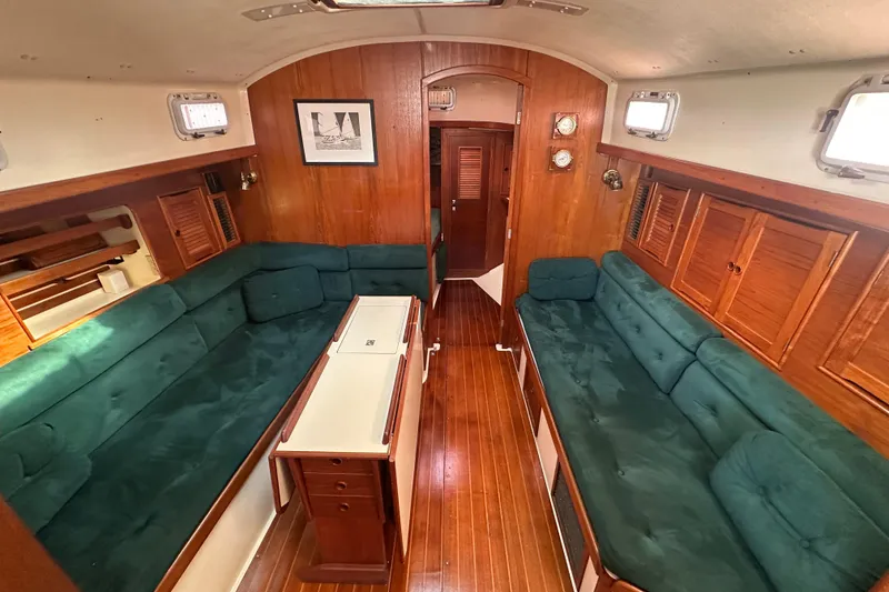 Slide: The Image of Interior of 1989 Nonsuch 36 sailboat with green seating and wooden finishes. - 17