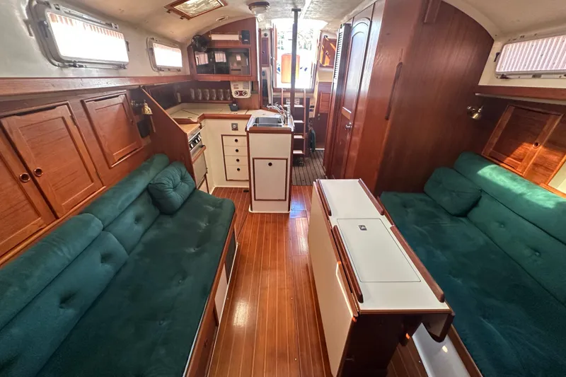 Slide: The Image of Interior of 1989 Nonsuch 36 sailboat with wood finish and green seating. - 22