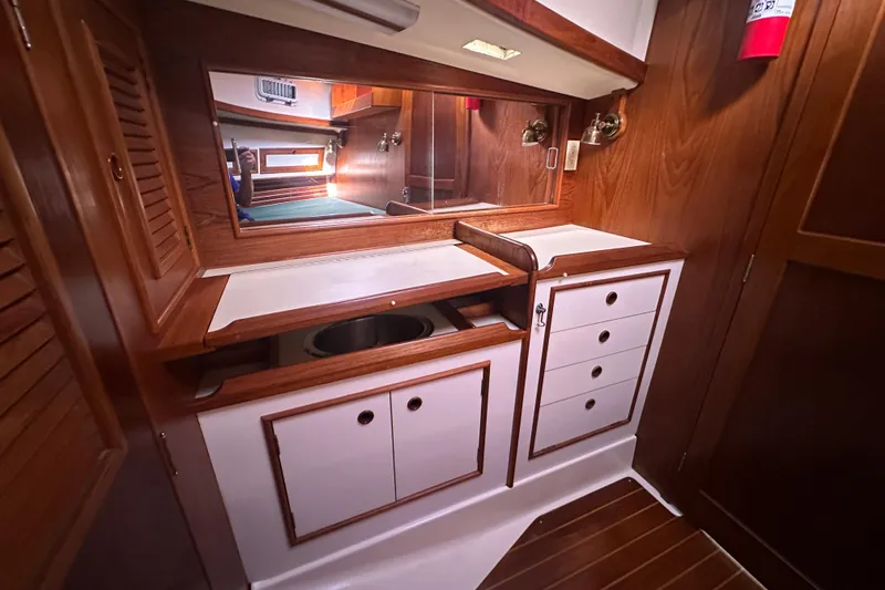 Slide: The Image of 1989 Nonsuch 36 yacht interior with wooden cabinetry and mirror. - 33