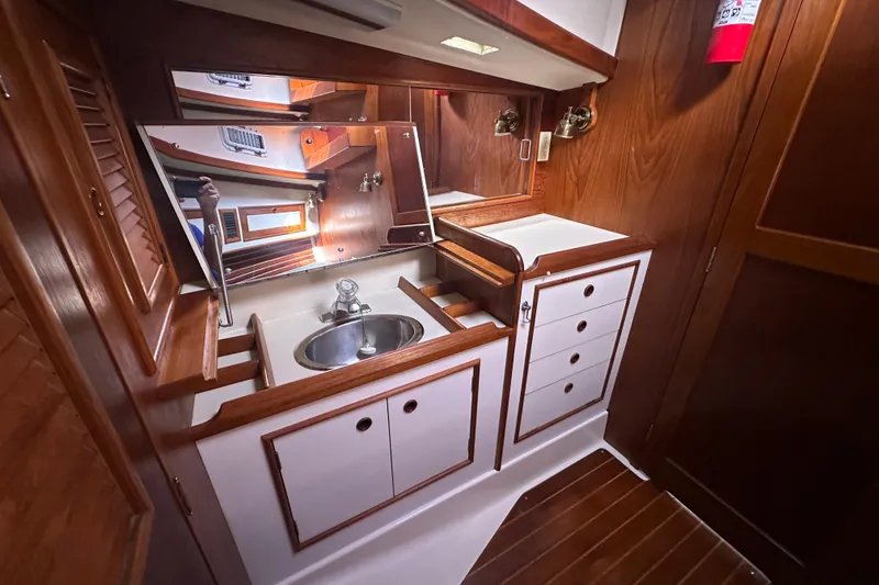 Slide: The Image of 1989 Nonsuch 36 yacht interior with wooden cabinetry and sink. - 34