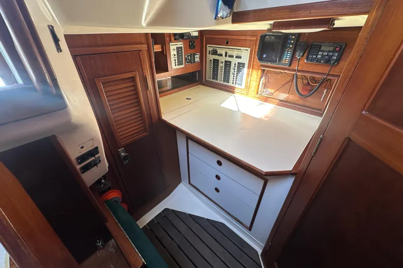 Slide: The Image of 1989 Nonsuch 36 yacht interior with navigation station and wooden cabinetry. - 35