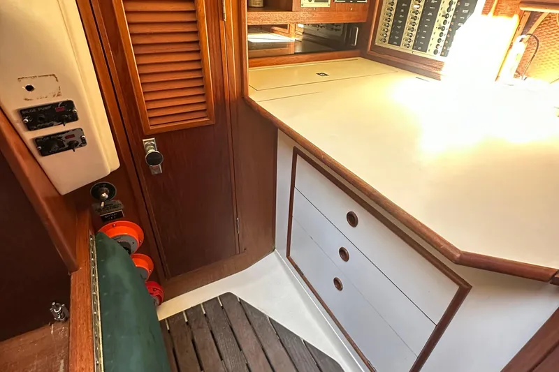 Slide: The Image of Interior of 1989 Nonsuch 36 sailboat with wooden cabinetry and control panels. - 36