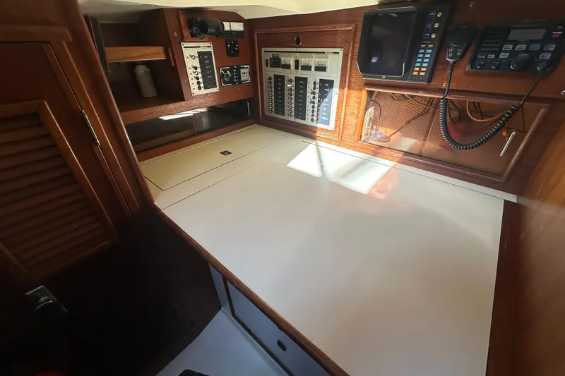 Slide: The Image of Navigation station of 1989 Nonsuch 36 sailboat with control panels and communication equipment. - 37