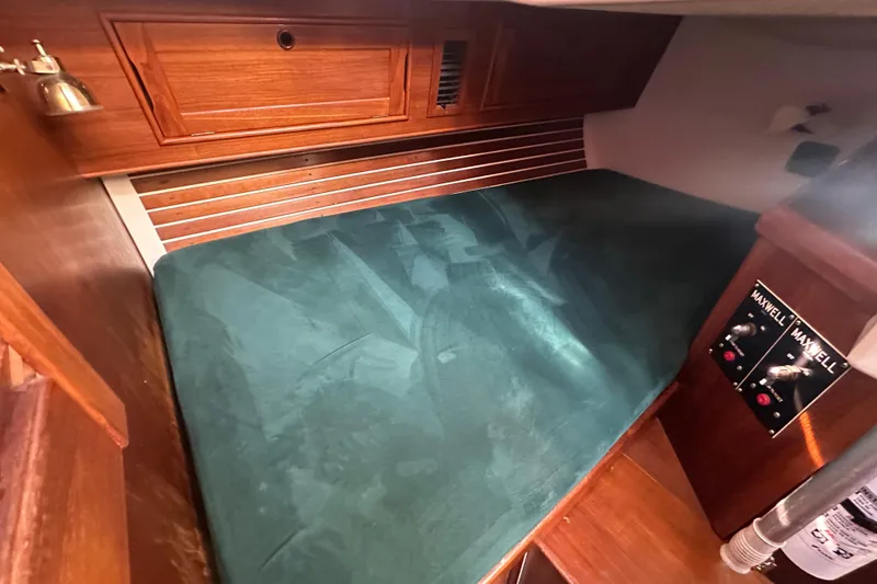 Slide: The Image of Cozy cabin interior of 1989 Nonsuch 36 sailboat with green mattress and wooden accents. - 41
