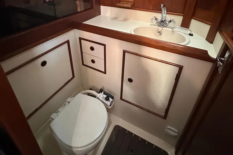 Slide: The Image of 1989 Nonsuch 36 yacht bathroom with wooden cabinetry and modern fixtures. - 42