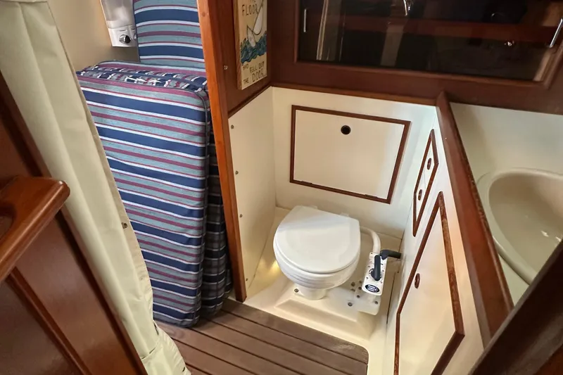Slide: The Image of 1989 Nonsuch 36 yacht interior with wooden flooring and compact bathroom. - 45