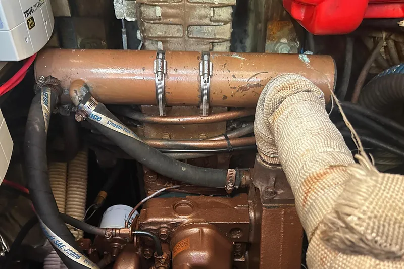 Slide: The Image of Engine compartment of a 1989 Nonsuch 36 sailboat, showing detailed mechanical components. - 49
