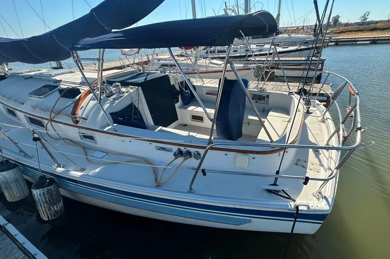 Slide: The Image of 1989 Nonsuch 36 sailboat docked, featuring spacious cockpit and sleek design. - 7