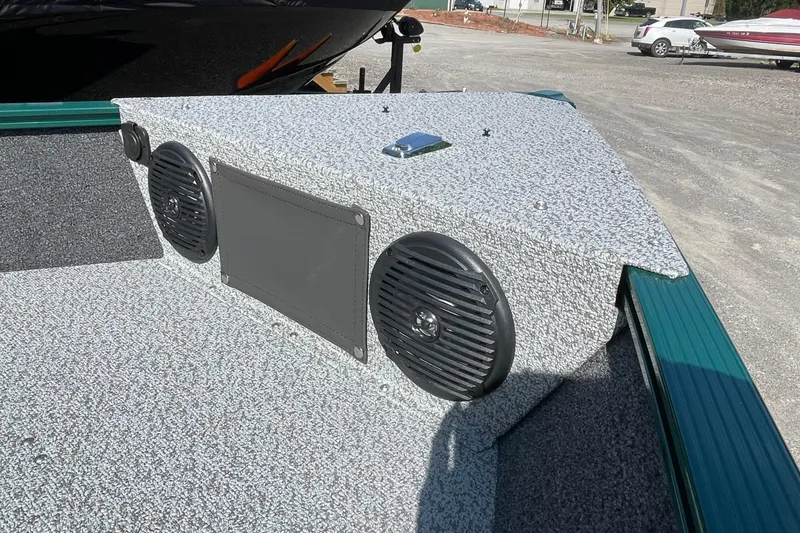 Slide: The Image of 2026 Lund 1650 Angler Sport boat interior with speakers and textured flooring. - 10