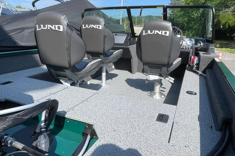 Slide: The Image of 2026 Lund 1650 Angler Sport boat interior with three seats and steering console. - 12