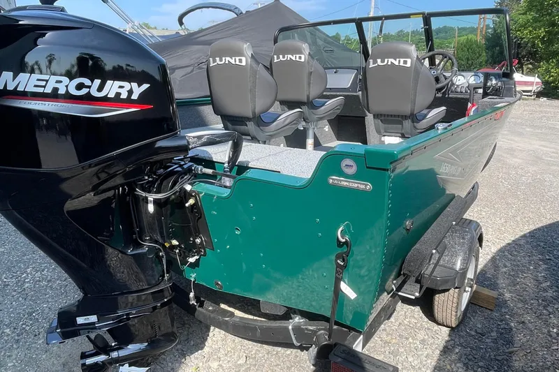 Slide: The Image of 2026 Lund 1650 Angler Sport boat with Mercury engine, green exterior, and dual seats. - 3
