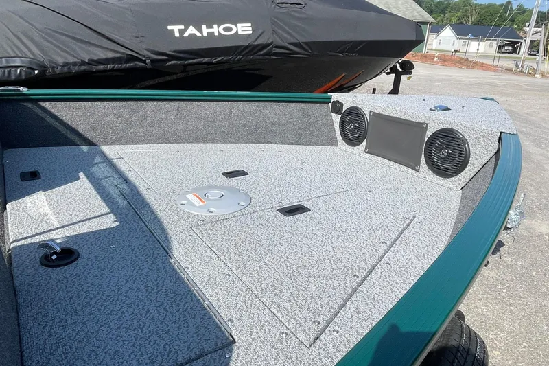 Slide: The Image of 2026 Lund 1650 Angler Sport boat deck with speakers and storage compartments. - 5