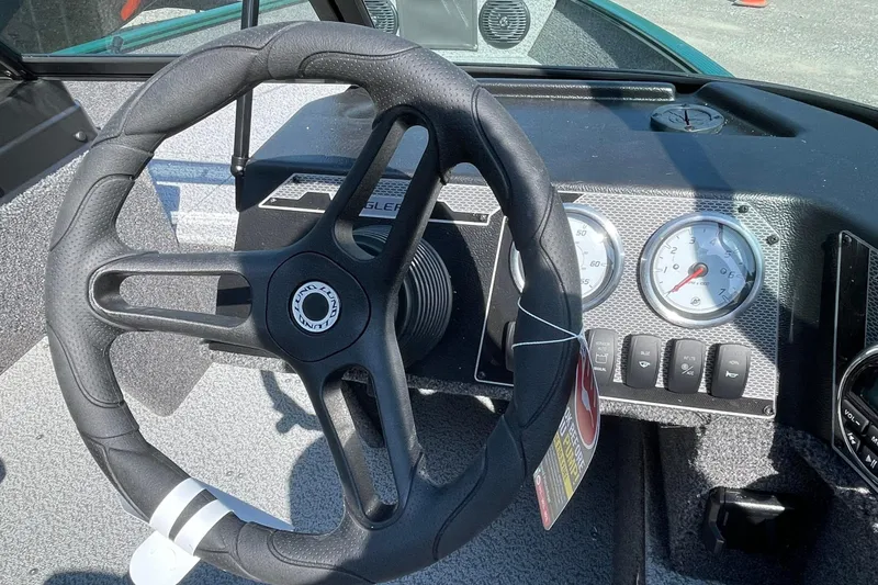 Slide: The Image of Steering wheel and dashboard of 2026 Lund 1650 Angler Sport boat, featuring gauges and controls. - 7