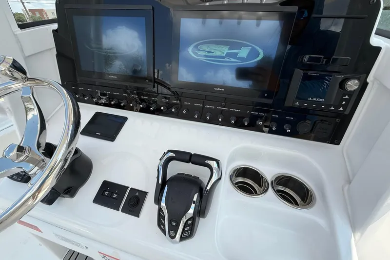 Slide: The Image of 2026 Sea Hunt Gamefish 27 Coffin Box dashboard with dual Garmin displays and controls. - 18