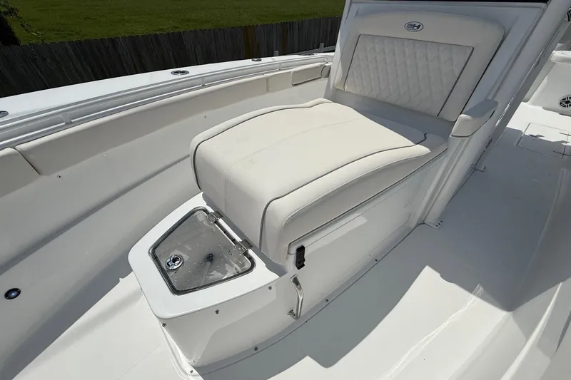 Slide: The Image of 2026 Sea Hunt Gamefish 27 Coffin Box boat interior with cushioned seating and storage. - 22