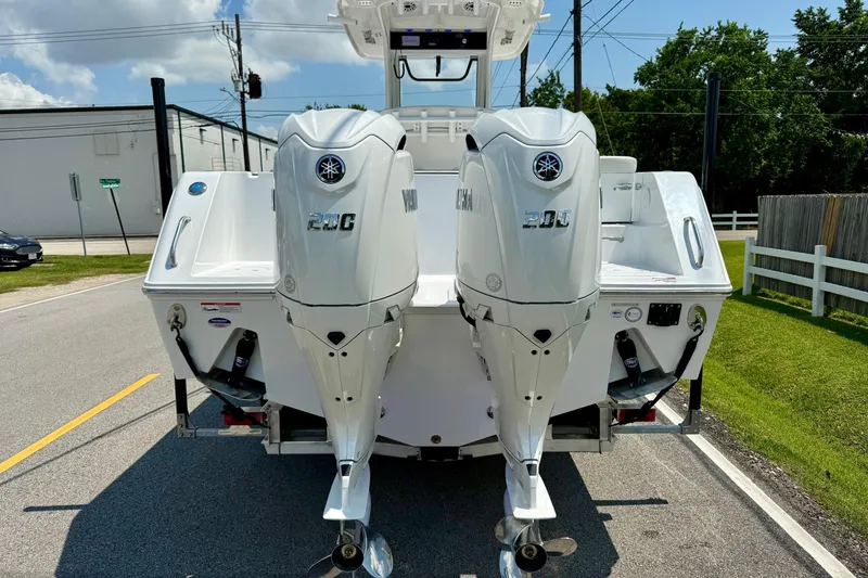 Slide: The Image of 2026 Sea Hunt Gamefish 27 Coffin Box with dual Yamaha 200 engines on a sunny street. - 3
