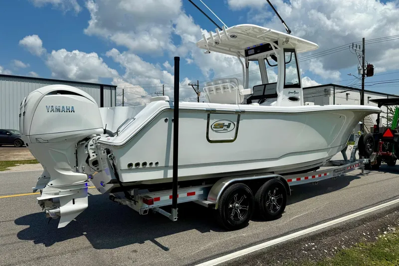 Slide: The Image of 2026 Sea Hunt Gamefish 27 Coffin Box boat on trailer, featuring Yamaha engine. - 4