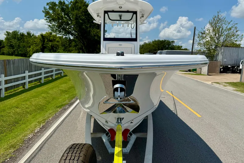Slide: The Image of 2026 Sea Hunt Gamefish 27 Coffin Box boat on trailer, parked on a sunny road. - 6