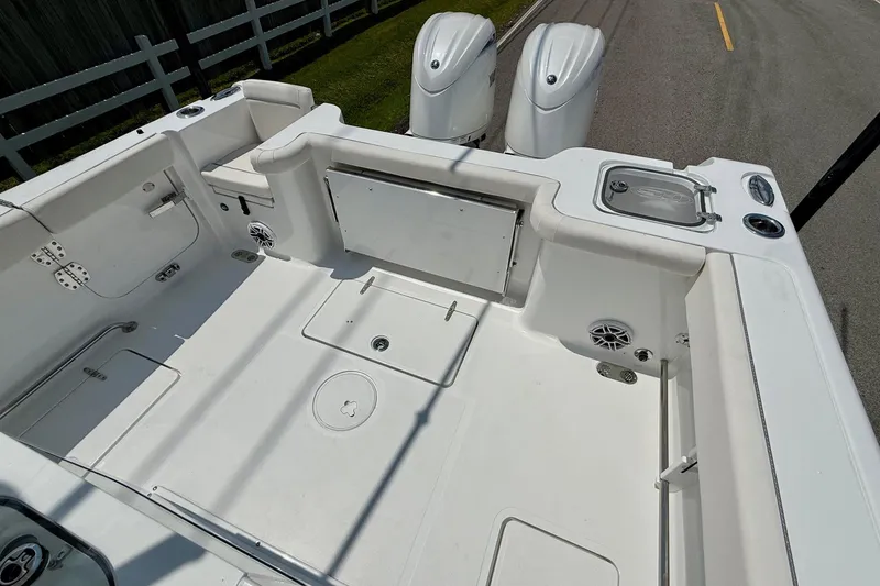 Slide: The Image of 2026 Sea Hunt Gamefish 27 Coffin Box boat interior with dual engines and spacious deck. - 8