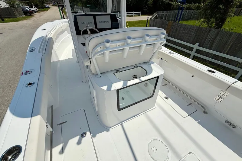 Slide: The Image of 2026 Sea Hunt Gamefish 27 Coffin Box boat interior with Garmin displays and rod holders. - 9