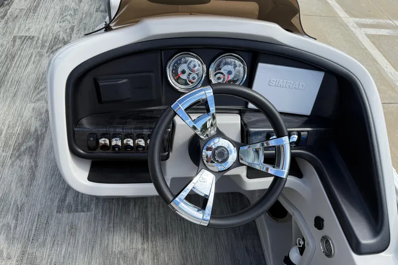 Slide: The Image of 2022 Avalon Catalina VRL 25' dashboard with chrome steering wheel and modern gauges. - 23