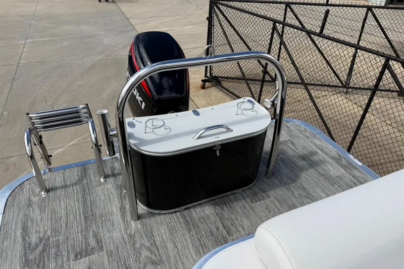 Slide: The Image of 2022 Avalon Catalina VRL 25' boat with motor and ladder, docked on concrete. - 28