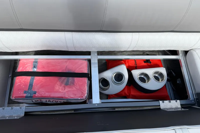 Slide: The Image of Storage compartment in 2022 Avalon Catalina VRL boat with life jackets and cup holders. - 37